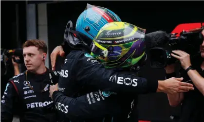  ?? Photograph: Amanda Perobelli/Reuters ?? Russell and Lewis Hamilton embrace after the race.