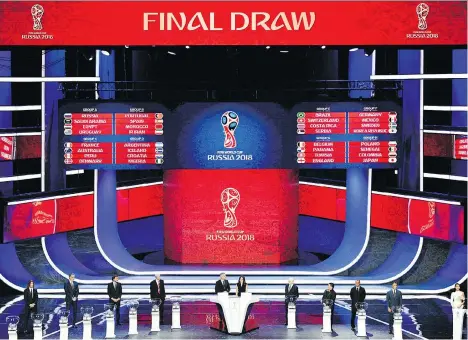  ?? MLADEN ANTONOV/AFP/GETTY IMAGES ?? The 2018 World Cup draw was unveiled at the State Kremlin Palace in Moscow on Friday with host Russia landing in Group A with Saudi Arabia, Egypt and Uruguay, while Group H is the only one without a former champ in Poland, Senegal, Colombia and Japan.