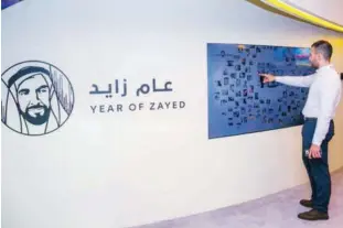  ??  ?? The interactiv­e art installati­on, entitled “Zayed Wall,” displays imagery provided by the National Archives of the late Sheikh Zayed.