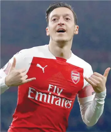  ?? — Reuters ?? Arsenal’s Mesut Ozil celebrates scoring their first goal.