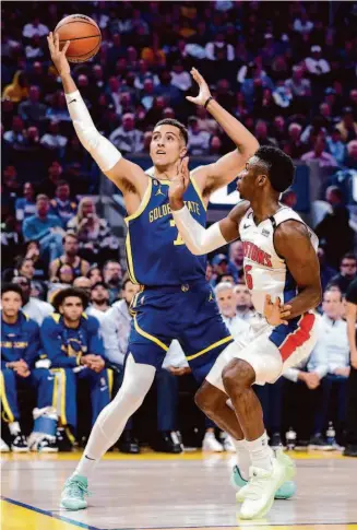  ?? Scott Strazzante/The Chronicle ?? Warriors forward Patrick Baldwin Jr. gets a rebound against Detroit’s Hamidou Diallo on Jan. 4.