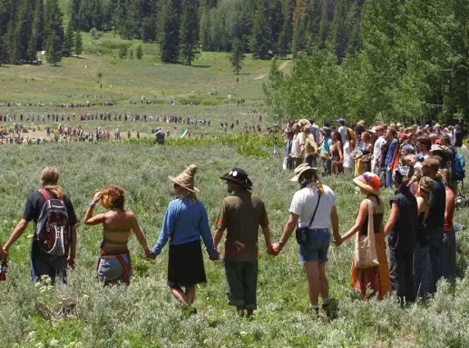  ?? Peter M. Fredin, Associated Press file ?? Rainbow Family members hold hands as they gather for their annual prayer circle in a meadow in the Routt National Forest north of Steamboat Springs on July 4, 2006.