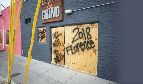  ?? Bloomberg ?? ■ A message of hope is scrawled on wooden barricades at a property ahead of Hurricane Florence in Carolina Beach, North Carolina. No hurricane has ever made landfall in the state.