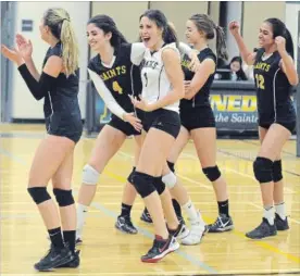  ?? DAVID BEBEE WATERLOO REGION RECORD ?? Members of the St. Benedict Saints girls senior volleyball team celebrate their playoff win over St. David Celtic in a hard-fought battle at St. Benedict.