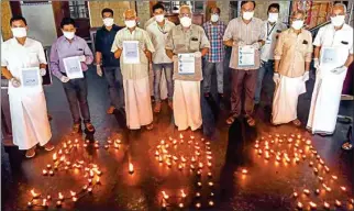  ?? PTI ?? People place lamps in a formation that reads 5.9.9 as they appeal for support for Prime Minister Narendra Modi’s announceme­nt to light lamps at 9 pm for nine minutes on April 5 to express unity against COVID-19, in Kochi, on Saturday