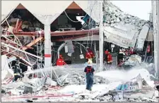  ?? (AFP) ?? Firefighte­rs spray the site of a blast in Doha with water as Qatari state television said ‘gas cylinder’ explosion in the Gulf emirate’s capital Doha killed and wounded several people on Feb 27.
