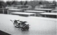  ?? Markus Schreiber / Associated Press ?? A red rose lies on a slab of the Holocaust Memorial to commemorat­e the victims of the Nazis in Berlin.