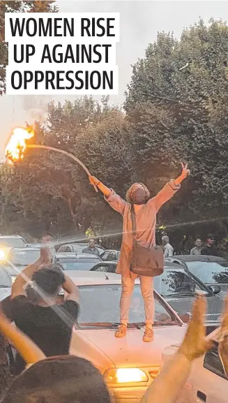  ?? ?? A woman sets a headscarf on fire in Tehran in protest over the death of Mahsa Amini.