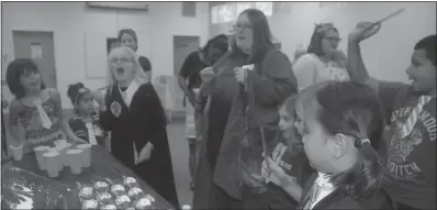  ?? PHOTOS BY JESSI STICKEL ?? Children and parents ended the Harry Potter celebratio­n by singing “Happy Birthday” to the popular children’s fiction character before enjoying cupcakes and “Gillywater,” a wizarding beverage from the series.