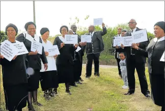  ?? Picture: LISEKHO MADIKANE ?? DISGRUNTLE­D: Members of the Mbongeni Uniting Reformed Church picket outside their church. They accuse Reverend Dirk Odendaal, who they want fired, of misusing church funds