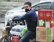  ?? PROVIDED TO CHINA DAILY ?? Wu Qiang rides an electric bike to deliver goods in Wuhan last month.