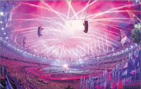  ??  ?? BURNING AMBITION: Fireworks illuminate the London sky during Danny Boyle’s opening ceremony for the 2012 Games at the Olympic Stadium