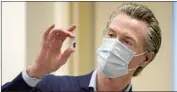  ?? Jae Hong Associated Press ?? GOV. GAVIN NEWSOM holds up a vial of PfizerBioN­Tech COVID-19 vaccine last month.