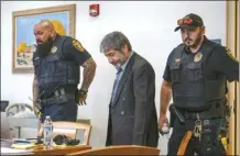  ?? Chancey Bush / The Albuquerqu­e Journal pool photo via AP ?? Muhammad Syed enters the court room before opening statements at the Bernalillo County Courthouse in Downtown Albuquerqu­e, N.M,, on Tuesday. Syed, an Afghan refugee, is accused in the slayings of three Muslim men in Albuquerqu­e.