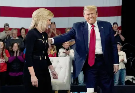  ?? ?? Trump (right) greets host Laura Ingraham as he arrives for a Fox News Town Hall event at the Greenville Convention Center in Greenville, South Carolina.