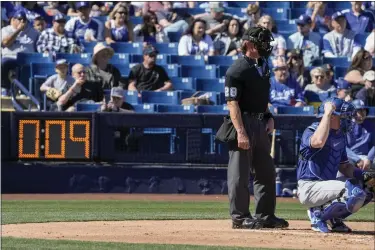  ?? MORRY GASH — THE ASSOCIATED PRESS ?? Home plate umpire Jim Wolf waits as the pitch clock counts down during the first inning of a spring training baseball game between the Milwaukee Brewers and the Los Angeles Dodgers Saturday, Feb. 25, 2023, in Phoenix.