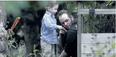  ?? LARS HAGBERG/THE CANADIAN PRESS ?? Joshua Boyle and one of his kids play in the garden at his parents house in Smiths Falls, Ont., on Saturday.