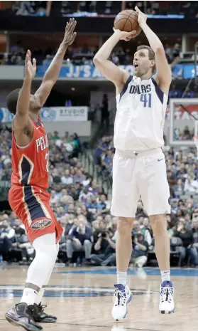  ?? / AP FOTO ?? NO. 6. Dallas Mavericks forward Dirk Nowitzki shoots over Darius Miller in the second half against the New Orleans Pelicans. Nowitzki scored eight points and passed Wilt Chamberlai­n for sixth place in the NBA career scoring list.