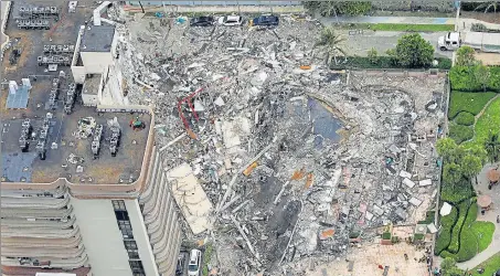  ?? REUTERS ?? A large section of the building in Surfside, US, which collapsed on Thursday, is seen lying scattered over a wide area.