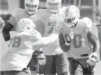  ?? TAIMY ALVAREZ/SUN SENTINEL ?? left, and Ja’Wuan James, right, run through drills during practice Tuesday.