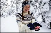  ?? JENNIFER KENT — UNIVERSITY OF NEVADA, RENO, VIA AP ?? University of Nevada, Reno, student Michelle Werdann feeds a wild mountain chickadee pine nuts at Chickadee Ridge in Mount Rose Meadows, Nevada, on Jan. 6.