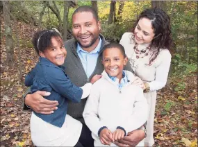  ?? Contribute­d photo ?? Six-year-old Ana Grace Márquez-Greene, left, sits with her father, Jimmy Greene, brother Isaiah and mother Nelda Márquez-Greene. Ana Grace was one of the Sandy Hook Elementary School victims.
