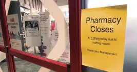  ?? TOM MURPHY AP ?? A sign is posted outside a CVS pharmacy on Thursday in Indianapol­is. A rush of vaccine-seeking customers and staff shortages are squeezing drugstores around the country. That has led to frazzled workers and even temporary pharmacy closures.