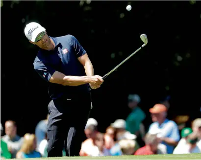  ?? AP ?? Adam Scott of Australia hits to the 15th green during a practice round for the Masters golf tournament on Monday. —