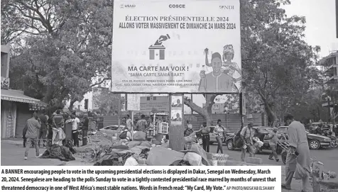  ?? AP PHOTO/MOSA'AB ELSHAMY ?? A banner encouragin­g people to vote in the upcoming presidenti­al elections is displayed in dakar, senegal on Wednesday, March 20, 2024. senegalese are heading to the polls sunday to vote in a tightly contested presidenti­al race marred by months of unrest that threatened democracy in one of West Africa’s most stable nations. Words in French read: “My Card, My Vote.”