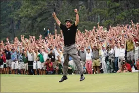  ?? DAVE MARTIN / ASSOCIATED PRESS FILE ?? April 11, 2004: Phil Mickelson’s agonizing pursuit of a major ends at the Masters when he makes an 18-foot birdie putt on the final hole, ending a spectacula­r back-nine duel with Ernie Els.