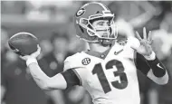  ?? LYNNE SLADKY/AP ?? Georgia quarterbac­k Stetson Bennett passes against Michigan during the Orange Bowl on Friday in Miami Gardens, Fla.