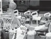  ?? STACY REVERE/GETTY ?? Giannis Antetokoun­mpo dunks during the Bucks’ 107-96 victory over the Nets in Game 4 of the Eastern Conference semifinals Sunday in Milwaukee.