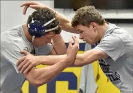  ??  ?? Brothers Luke and Mac Stout work out during wrestling practice Monday at Mt. Lebanon High School.