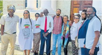  ?? PHOTO BY GARETH DAVIS SR ?? Dr Devon Taylor (right), president of Jamaica Beach Birthright Environmen­tal Movement (JaBBEM), and attorney Marcus Goffe (second right) along with members of JaBBEM at the Portland Parish Court yesterday.