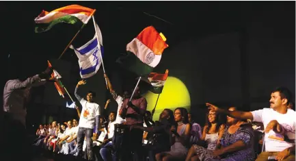  ?? (Ammar Awad/Reuters) ?? PEOPLE DANCE with Israeli and Indian flags during a reception held by Indian Prime Minister Narendra Modi for the Indian community in Israel, in Tel Aviv, yesterday.