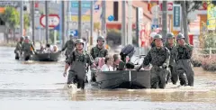  ??  ?? Japan Self-Defence Force soldiers rescue people from a flooded area in Mabi on July 8.