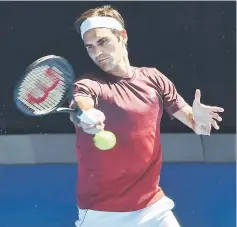  ?? — AFP photo ?? Switzerlan­d’s Roger Federer hits a return during a practice session ahead of the start of the Australian Open tennis tournament in Melbourne.