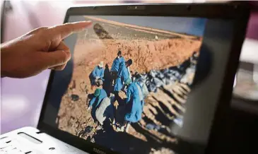  ??  ?? Grave crime: sirwan Jalal, director of Mass graves for the Kurdish Regional government, points to an image of the site of a mass grave in Irbil, northern Iraq. — AP