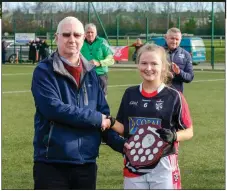  ??  ?? Jim Murphy presents the Senior ‘A’ Shield to Sarah Evans of Dominican College after the final in Bray last week.