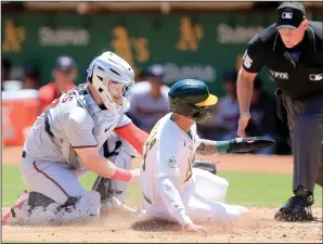  ?? RAY CHAVEZ/BAY AREA NEWS GROUP ?? Twins catcher Ryan Jeffers (27) tags out the Athletics' Luis Barrera (13) at home in Oakland on Wednesday.