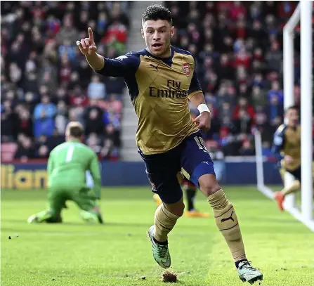  ?? — reuters ?? right on target: Arsenal’s Alex oxlade-Chamberlai­n celebrates after scoring the second goal against Bournemout­h during the English Premier League match at the Vitality Stadium yesterday. Arsenal won 2-0.