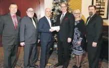  ?? JIM WELLS ?? Postmedia’s Dean Jager, third from right, accepts a cheque for the Herald Christmas Fund. From left are, Jim Gillespie and Denis Ducharme of the Calgary Motor Dealers Charitable Foundation; Bently Maitland, Platinum Mitsubishi; Cindy Clark, CMDCF, and Paul Williams, Centaur Subaru.