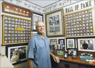  ?? GARY REYES/STAFF PHOTOS ?? Joe Galiardi, 80, shows off his collection of autographe­d golf balls at his home in Cupertino. His collecting obsession began around age 7 when he gathered sets of model planes, comic books and baseball cards.