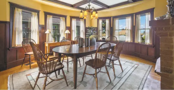  ?? Photos by Open Homes Photograph­y ?? Above: The formal dining room at 4191 Gilbert St. in Oakland has a coffered ceiling, a decorative fireplace and above average height wainscotin­g. Below left: The living room offers a fireplace, wide moldings and wood-framed windows. Below right: The...