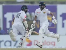  ?? AP ?? Dimuth Karunaratn­e, left, and Lahiru Thirimanne have put up Sri Lanka’s highest opening partnershi­p in the fourth innings