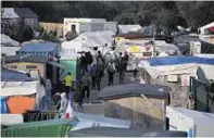  ??  ?? Migrants in the Jungle camp in Calais, France