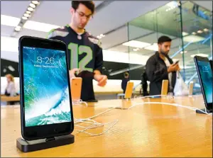  ?? AP/RICHARD VOGEL ?? The Apple iPhone 7 is displayed at the Apple Store at the Grove in Los Angeles in September. Qualcomm Inc., the chip company, is suing manufactur­ers of the iPhone.