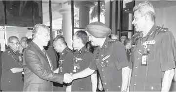  ??  ?? Deputy Prime Minister Datuk Seri Dr Ahmad Zahid Hamidi and Inspector-General of Police Tan Sri Mohamad Fuzi Harun (left) greeted by police officers at the meet-and-greet session with police personnel in Kuala Lumpur. - Bernama photo