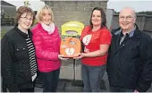  ??  ?? LIFE-SAVER Kevin’s family hand over defibrilla­tor