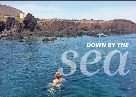  ?? FRANCES D’EMILIO/AP ?? A cove of pristine water is surrounded by volcanic rock formations on the island of Linosa, off southern Italy.